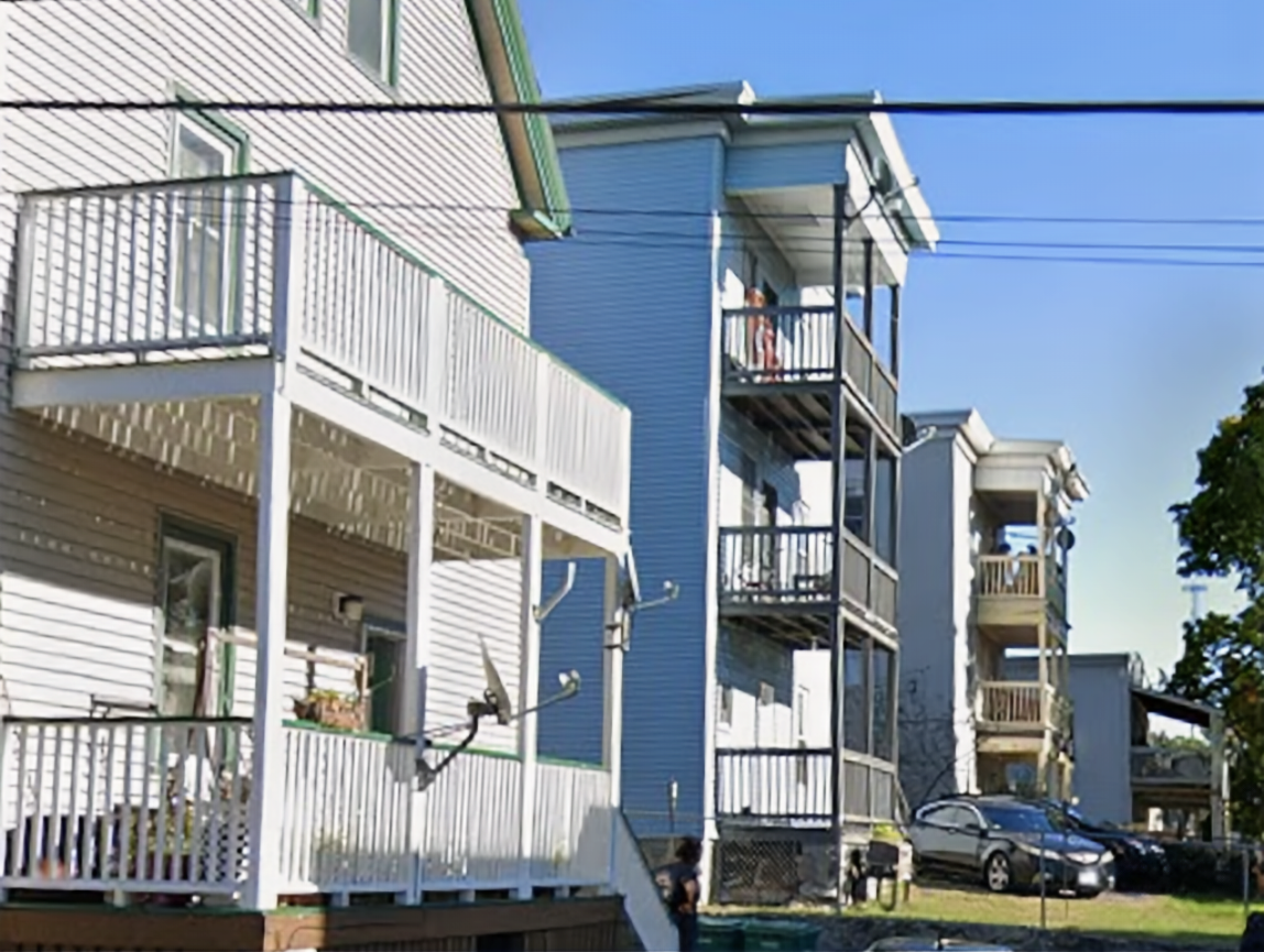 Rear porches on 3-story wood frame residences.